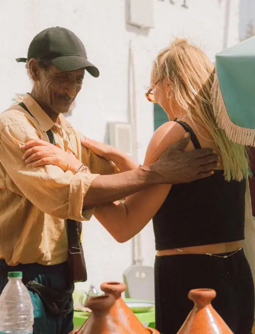 friendly imsouane local patting a tourist on the back