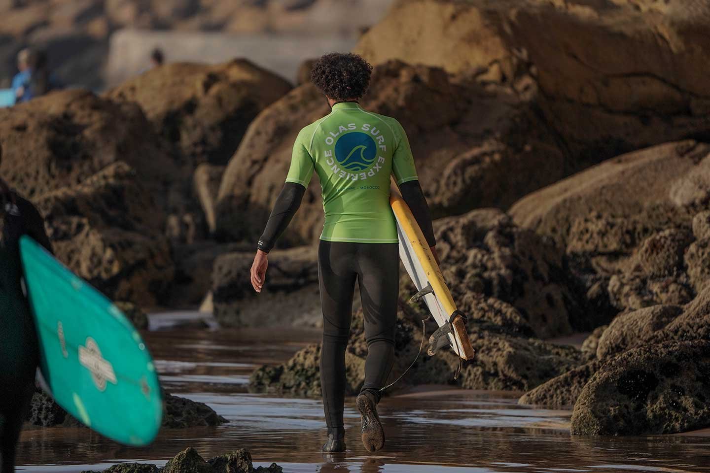 olas Surf instructor guiding a student